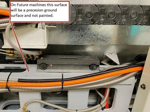 With the rear cover removed place the level on the machined surface of the casting that mounts the linear guides. This surface is used to level the machine in the Z or long Axis of the machine.