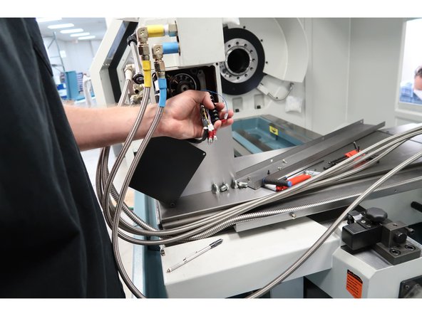 Route the hoses near the table in the lower cross slide. The five hoses and one electric line will fit in the cross slide with the top bolted in place. Use rubber hose clamps to control the hoses from the cable carrier up to the table.