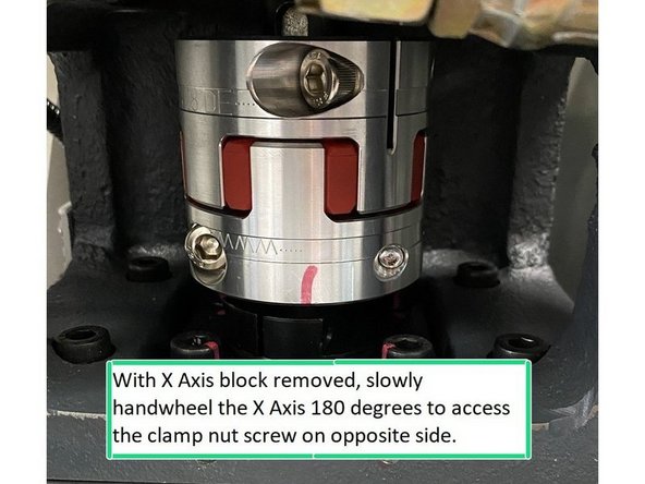 Enable the servos and enter service code 505, slowly jog off of the block on the X axis. Use the index angle display on the lower right of the screen to assist in slowly jogging the motor 180 degrees so that you can access the other clamp screw on the coupling to tighten it.
