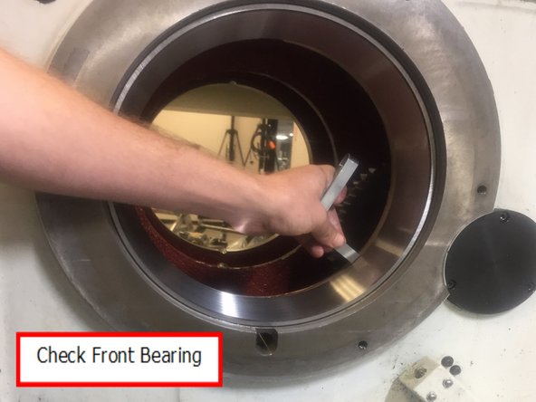 Remove the front bearing race retaining tool. Using a depth micrometer measure that the race is properly seated. Check in 4 places around the perimeter of the race at about 90o, the readings should not be different by more than .005”.