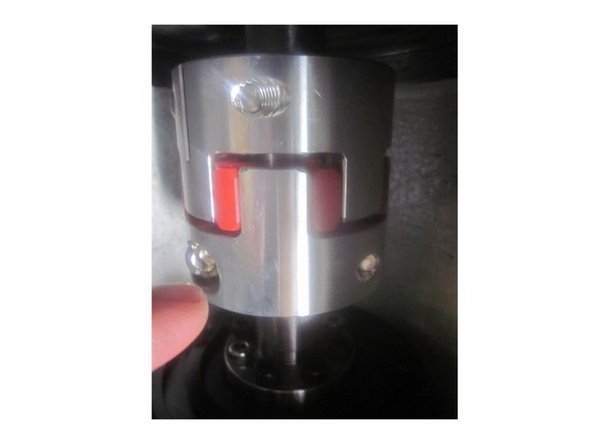 Break loose the lower spindle coupler screws.