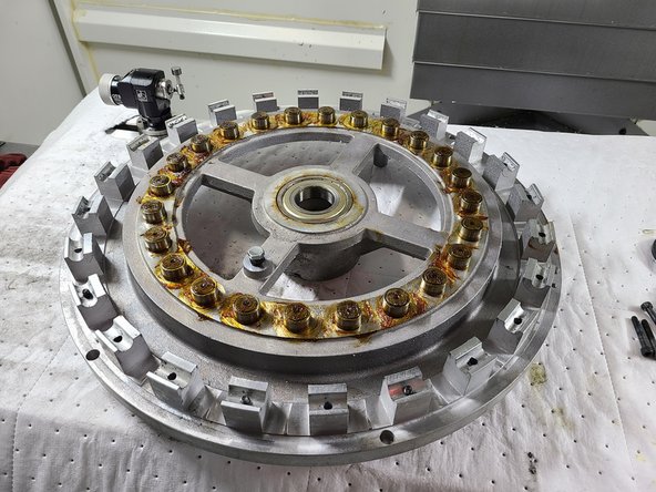 Use a 17mm wrench and 4mm Allen key to loosen and remove the roller bearings, washers, and nuts from the old carousel disc.