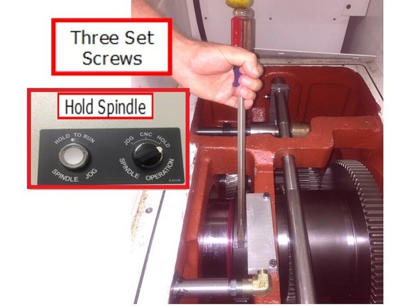 Use spindle hold feature (Inset photo)on the lathe to prevent the spindle from turning when loosening the lock nuts.
