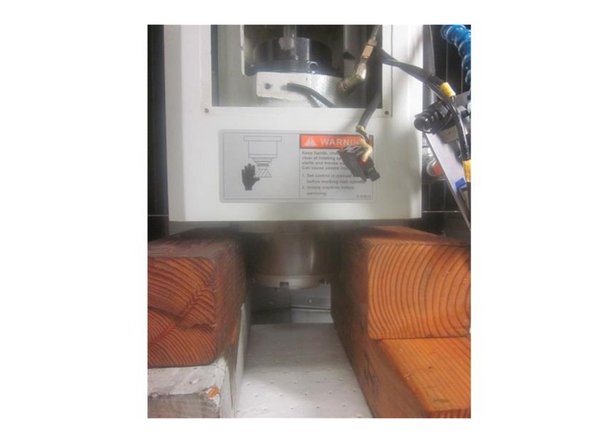 Lower the Z axis until the spindle  contacts the blocks. Loosen the front and rear bolts a bit then raise the Z axis to leave just a slight gap in between it and the spindle.