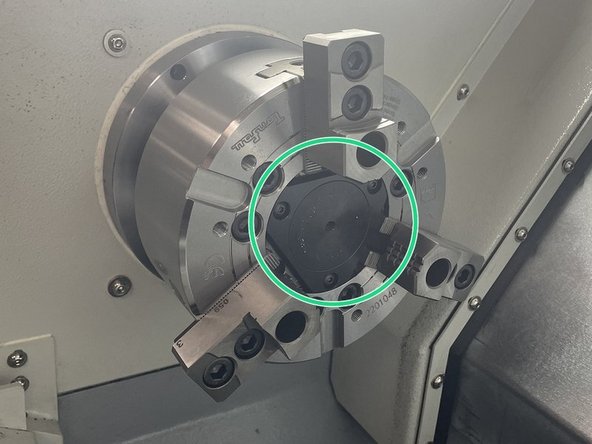 Reinstall the center cap and chuck jaws. The jaws and chuck are numbered, return the jaws to the corresponding location on the chuck. Torque the jaws to 47ft-lbs. See Photos 2 and 3
