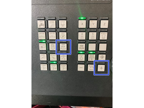 This procedure is best performed with two people. One person will press and hold the Green manual tool change button on the head of the machine.