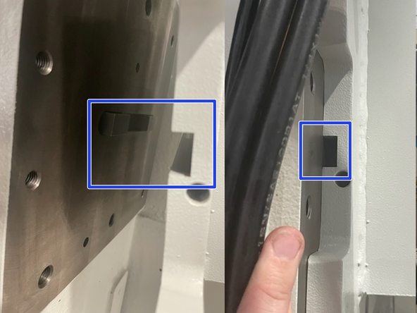 Take the slack out of the strap using the lifting apparatus and with an M14 Hex bit remove  the six (6) sets of mounting hardware holding the ATC bracket to the machine column.