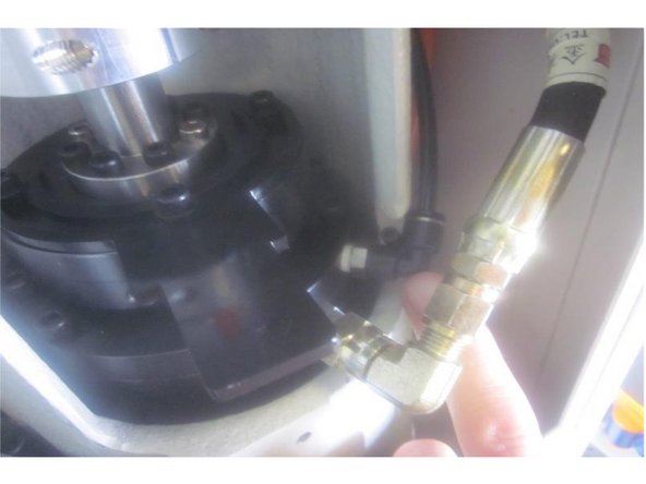 Clean any debris from the holes in the spindle where the air and hydraulic fittings attach. Clean the air and hydraulic fittings. Install Teflon tape on the portion threaded into the spindle. Install the air fitting first then connect the air line. Next do the same for the hydraulic oil line.