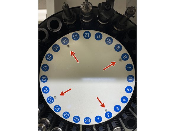 Unscrew the four hex socket screws securing the carousel cover.