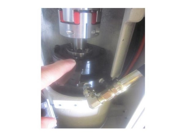 On M11's install the 90 degree spindle air line fitting in the main lower flange at the 3 o'clock position if replacing the spindle. Install the air line. Do not over tighten the line. Check that air flows through the end of the spindle.