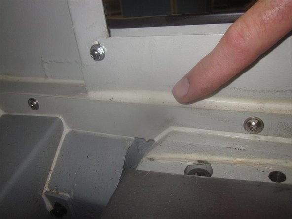 Install the drip pan under the Y motor. Install the sheet metal panels. Install the Y-Axis ball screw protective cover.