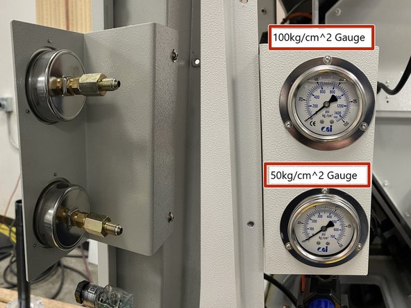 Locate the 35092-4 Gauge Bracket and both gauges. One(1) gauge is 100kg/cm^2 and the other is 50kg/cm^2. Install the gauges into the bracket with the higher pressure gauge (100kg/cm^2) in the top hole on the bracket. See Photo 1 for orientation. Install the bracket to the cabinet as shown in Photo 1.
