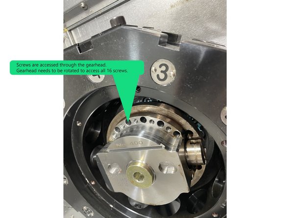 To remove the gearhead there are 16 screws that need to be removed. These screws are accessed through the front of the gearhead. The gearhead needs to be rotated to access all 16 screws. See Photo 2