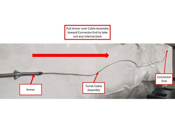 Place the Turret Logic Cable on a flat surface. Pull the moveable end of the Armor over the Cable Assembly toward the Connector End until it is fully extended. This is to take out any internal slack within the Armor.