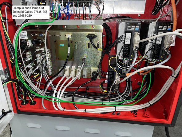 Route cables 27635-258 (Clamp In Solenoid) and 27635-259 (Clamp Out Solenoid) through the wire way above the computer module and down along the side of the cabinet and along the floor to the right rear corner of the cabinet. See Photo 2