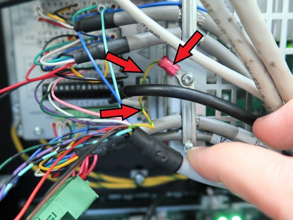 Install the Green/Yellow wire to the machine ground using a Torx T10 screw, as shown in the image.