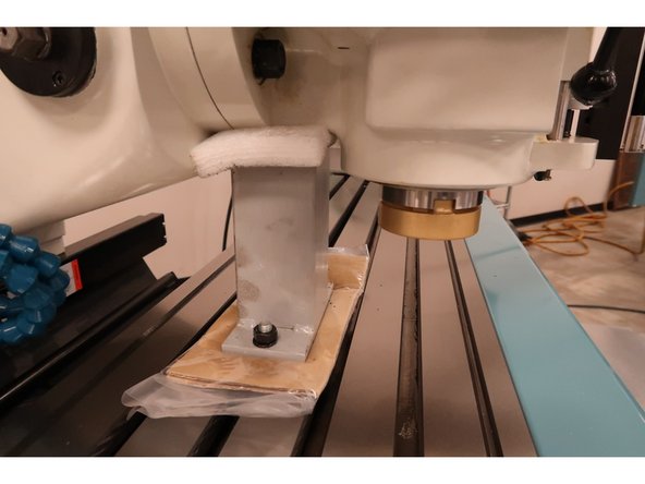 Jog the head down slowly on the Z-Axis until it bears down on the protective Styrofoam on top of the head shipping block.