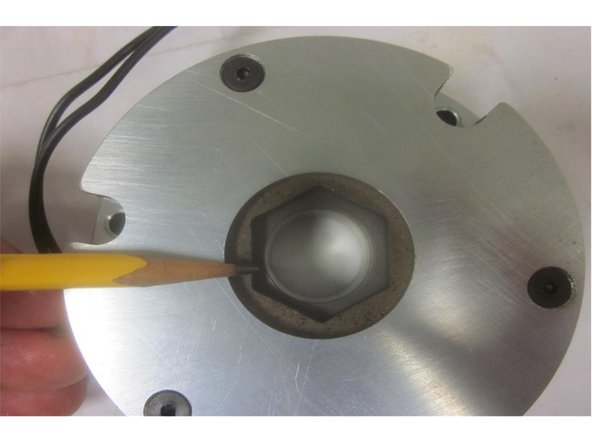 Carefully line up the brake so the hex in the friction disc fits in the &quot;coupling bushing.&quot; Lift up and turn the brake so the hex engages the coupling bushing. Rotate it to line up the mounting holes in the plate with the stand offs and install the screws. Re-connect the brake wire.