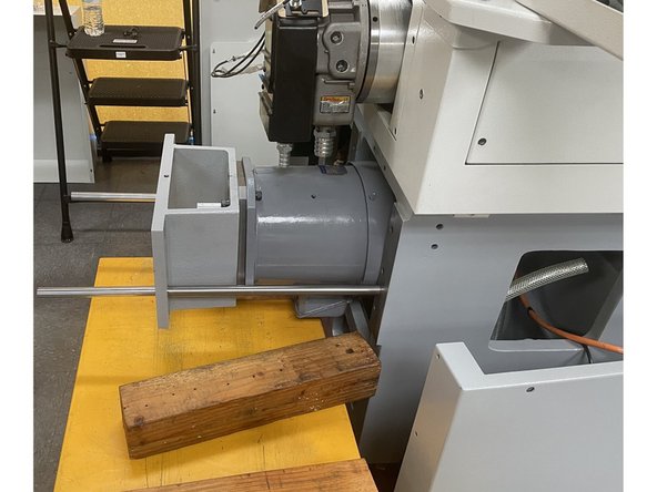 Use a height adjustable cart or some other lifting device to support the motor once it is out of the casting.