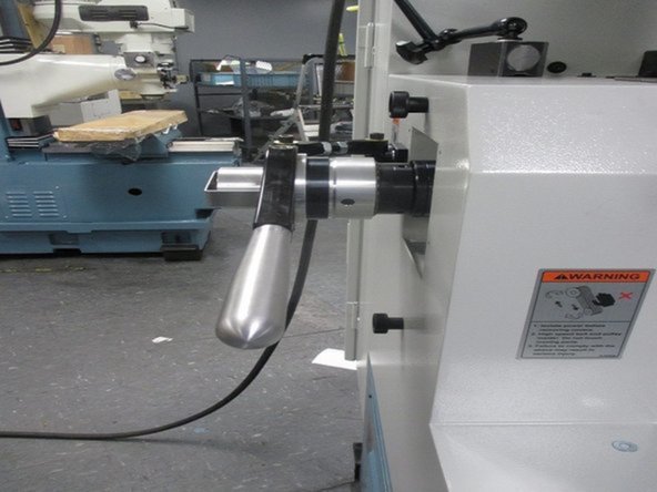 Continue rotating the clamping unit until tight, making sure to count the total number of rotations. Disengage the collet closer by pushing the handle toward the head stock. Rotate the clamping unit an additional quarter turn. Engage the collet closer by pushing the handle away from the head stock.