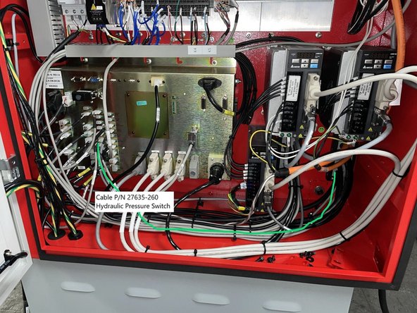 Locate cable P/N 27635-260 (Hydraulic Pressure Switch Cable) and connect to the computer module at IN-P29 and route down along the floor to the right rear corner of the cabinet. See Photo 1