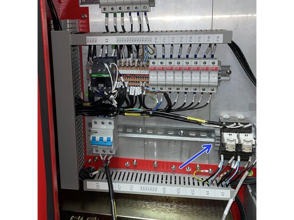 Remove the end stop on the DIN rail next to the K4 relay. See Photo 1