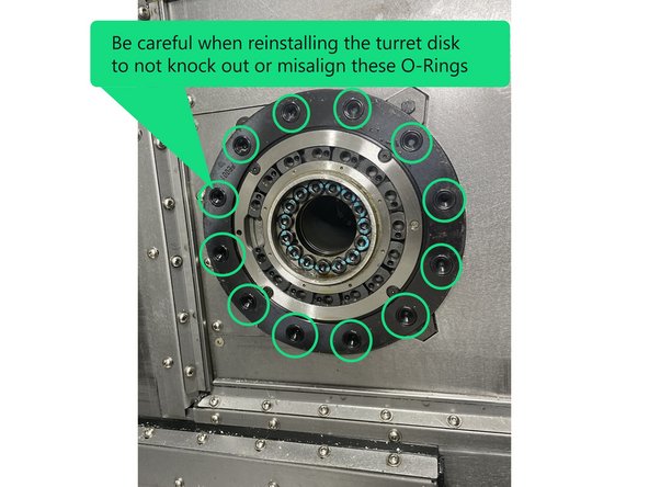 Using your lifting device raise up the turret disk and align it with the turret and slowly push it onto the taper in the turret. There is an O-Ring in the large center hole of the turret disk, be careful not to pinch or cut that O-Ring when reinstalling the turret disk.