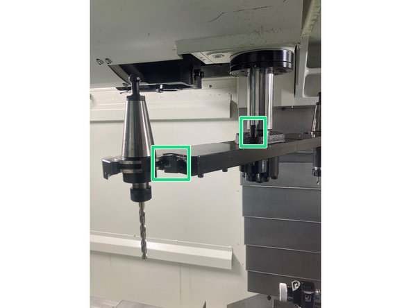 ** The green button must remain pressed until the tool is clear of the spindle.**