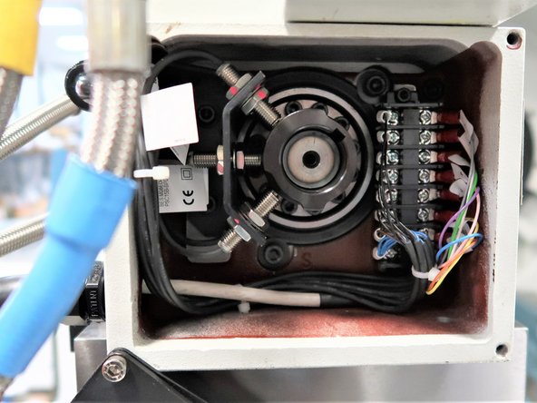 Once the Turret Logic Cable wires had been properly installed on the Sensor Housing Terminal Block, place the Terminal Block back inside the Sensor Housing by securing both top and bottom screws of the Terminal Block to their designated places. Place the Cover back on the Sensor Housing, and secure its four screws back on each of its corners.