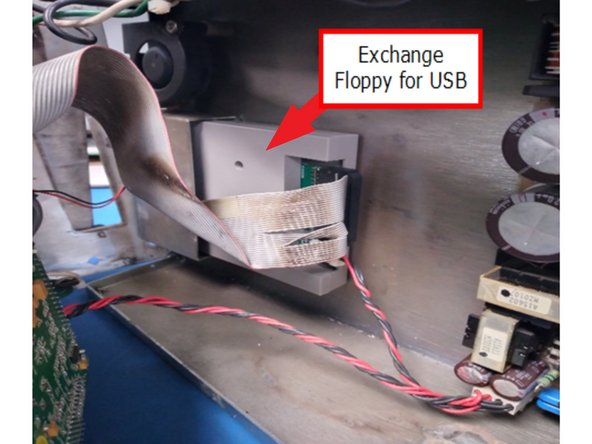 Remove the floppy drive, and then install the USB Emulator Drive with two (2) provided screws.