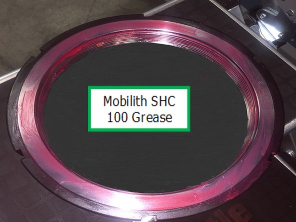 Next apply Mobilith SHC 100 or Similar grease to the spindle threads, lock nut threads, and ground  face of the lock nut.