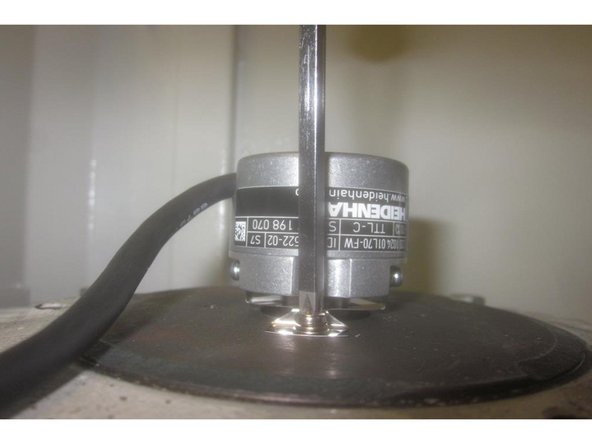 There are two (2) small set screws that tighten the encoder to the motor shaft. Using a 1.5mm hex key loosen both screws. Use caution as they are easily lost. Remove the two (2) small screws attaching the encoder to the motor housing and carefully remove the encoder.