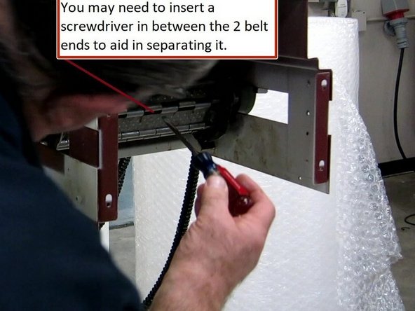 You may need to use a screw driver to assist in separating the belt once the main pin has been removed.
