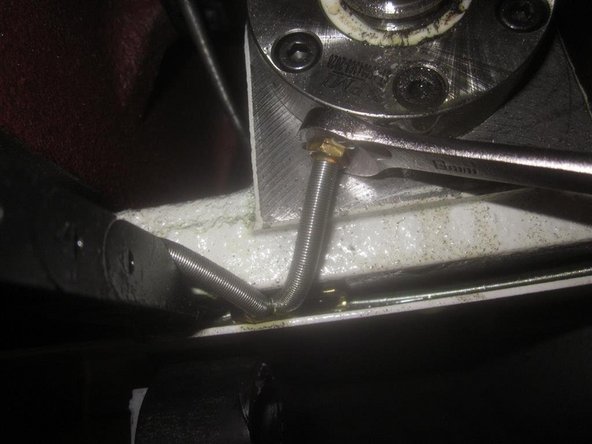 Remove the oil line attached to the ball nut. You can perform this before raising the bridge.