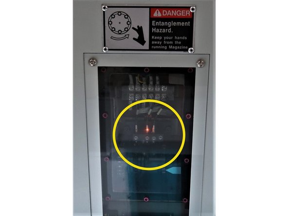 Remove bolt cover and rotate the 12mm socket clockwise until the ATC arm reaches its home position.