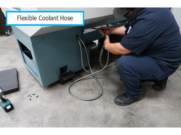 One end of the flexible hose follows the power cable into the small opening. The other end goes into the lathe work area.