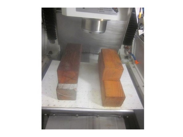 Place the four (4) wood 4 x 4 blocks  on the table on either side of the spindle. This setup allows you to easily get to the remaining bolts. Try to use blocks that are even heights as this eases removal and installation.