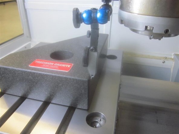 Place the granite stone on the table. Line up the long edge in X on the inside edge of the rear ball locks. Line up the Y side along the RH inside edge of the ball locks.