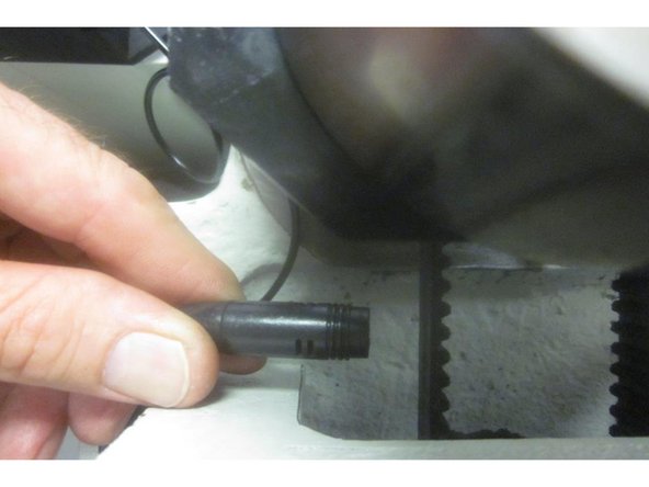 Remove the LH motor mounting screws. Remove the belt tension screw. Slide the motor forward and remove the belt.