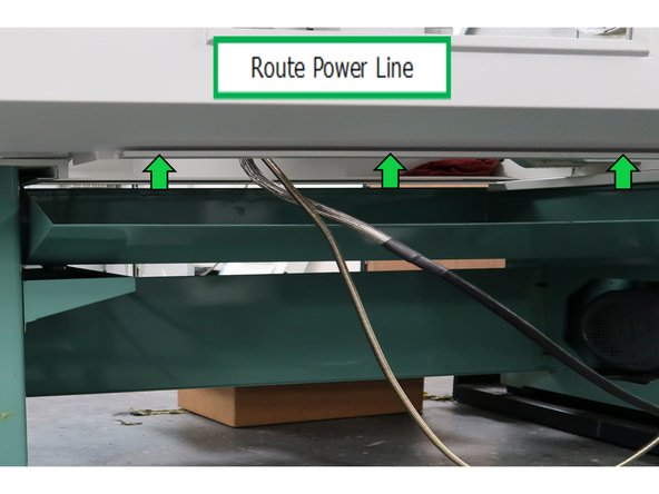 The coolant pump power cable gets routed through this trough all the way over to the electric cabinet. At the bottom right corner of the cabinet, there is an opening for wires. Insert the power cord through the opening and plug into the power outlet.