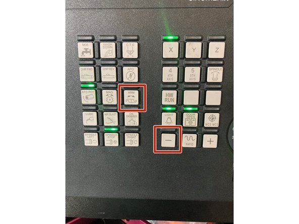 With the spindle in Service mode, Hold the [Arm] button and tap on the [+] button. This will bring the ATC arm back to the home position.