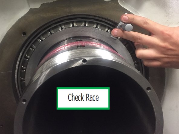 Remove rear spindle bearing race from freezer and install into casting and hold in place using 31098 clamping plate and (4X) M8x30 SHCS and washer. Leave clamping plate for at least 10 minutes for bearing race to come up to room temp, then remove.