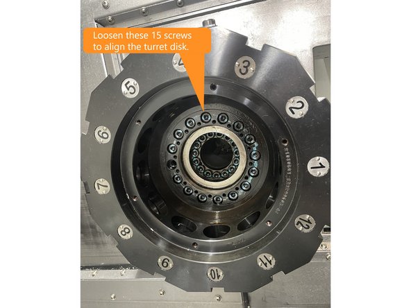 To align the turret disk loosen the 15 screws mounting the turret disk shown in Photo 1.