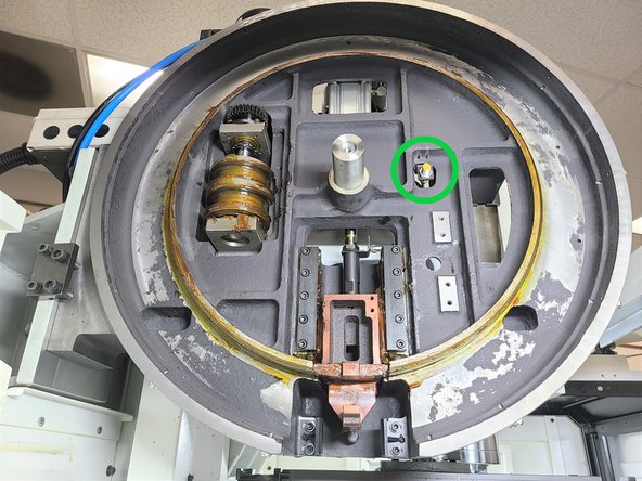 Illustration shows a close up of  the Home Position Sensor at the home position on the carousel.