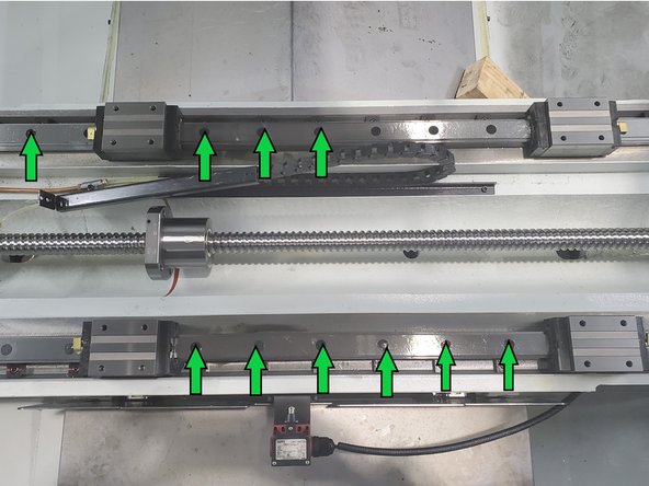 Remove all caps from Linear Guide rail mounting bolt counter bore holes. Pierce center of cap with awl and pry out. New caps are provided with Linear Guides. (Total of 44 caps)