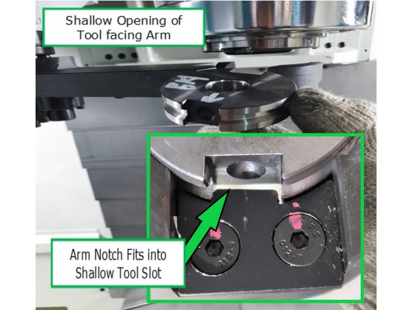 Push the locking lever on the arm while inserting the disk.