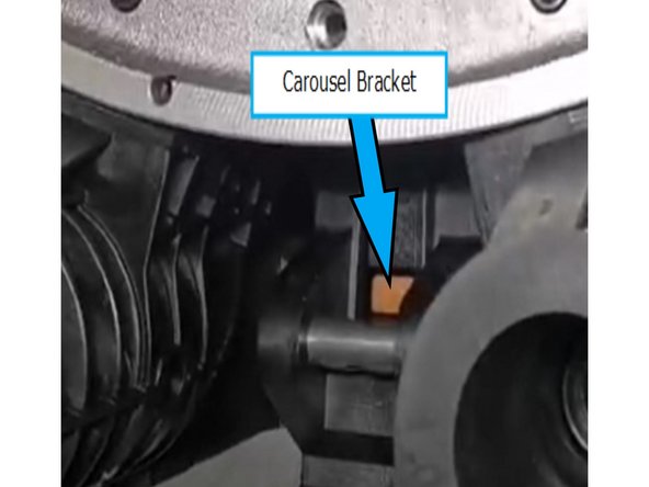 Slide the pot onto the carousel bracket, ensuring that the bracket slides between the pot housing and the spacer.