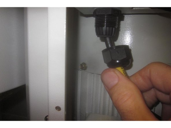 Using a small flat blade screwdriver, press the orange tabs on the tan colored wire connector to disconnect all the wires to the connector to allow removing the wires through the motor cover and junction box.