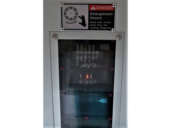 Remove bolt cover and rotate the 12mm socket clockwise until the ATC arm reaches its home position.