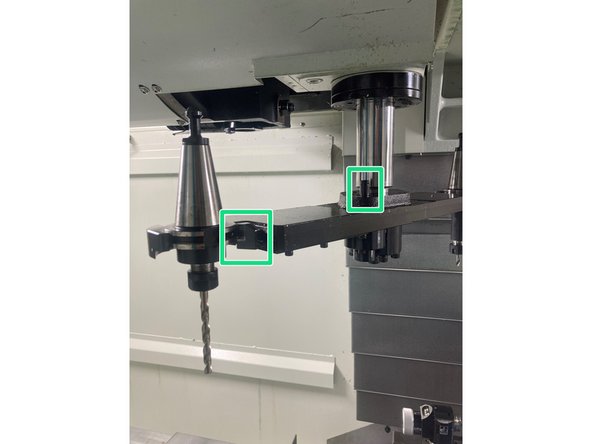 ** The green button must remain pressed until the tool is clear of the spindle.**